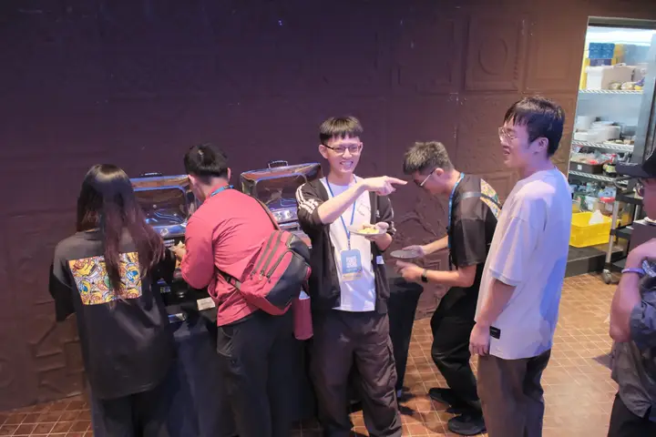 Event-tee crew deep in conversation — Taiwan Digital Night 2025 — Kaohsiung